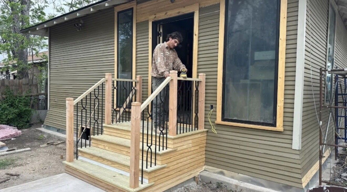 New wooden porch steps with metal railings